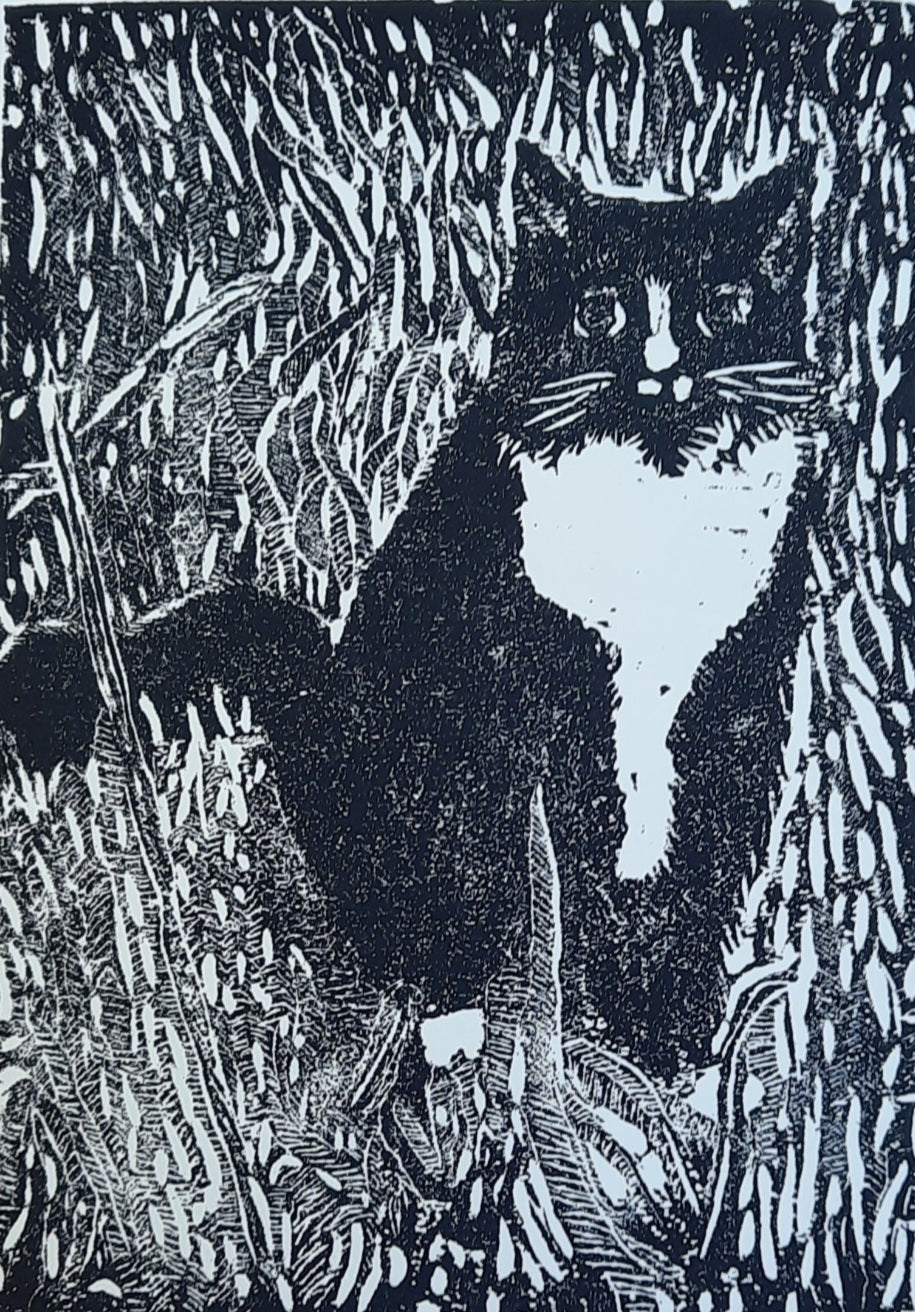 Woodcut print depicting a black and white cat surrounded by tall grass, titled 'Hearts for the Arts | Tuxedo', created by Hearts for the Arts. This artwork, framed at 12x9 inches, is valued at $200 and available for bidding to support art education.