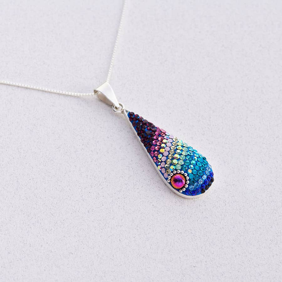 Morning Drop Pendant by Mosaico Jewels, showcasing elegant design with light-catching dew-like elements.
