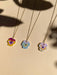 Three colorful Mini Pansy Necklaces by Sunnie Creative showcasing unique floral designs made of acrylic with stainless steel chains.