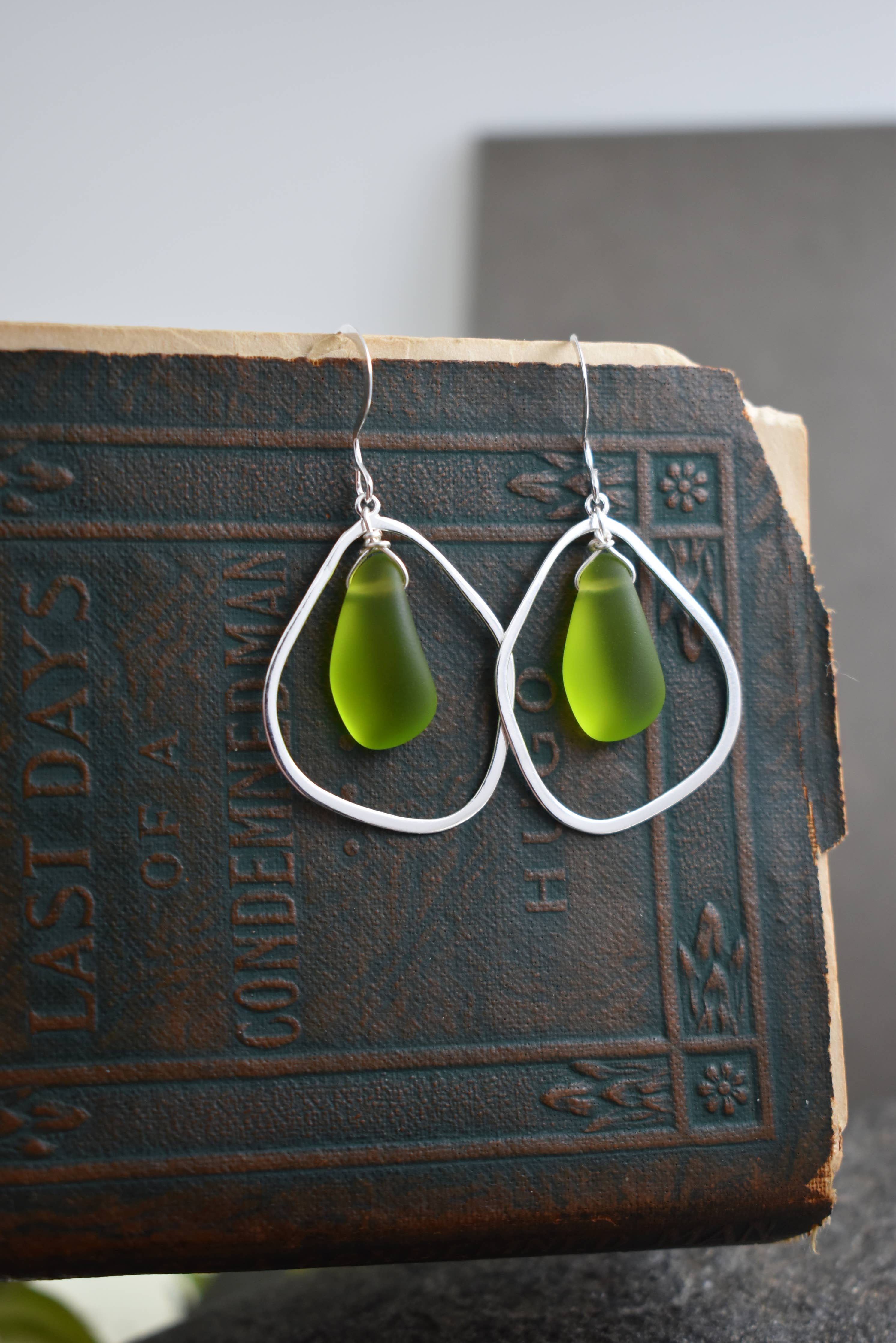 Handmade Green Eco Glass Teardrop Frame Earrings featuring sustainable materials and sterling silver ear hooks.