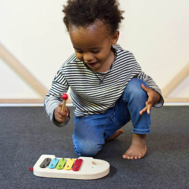 Boy playing Wooden Elephant Xylophone