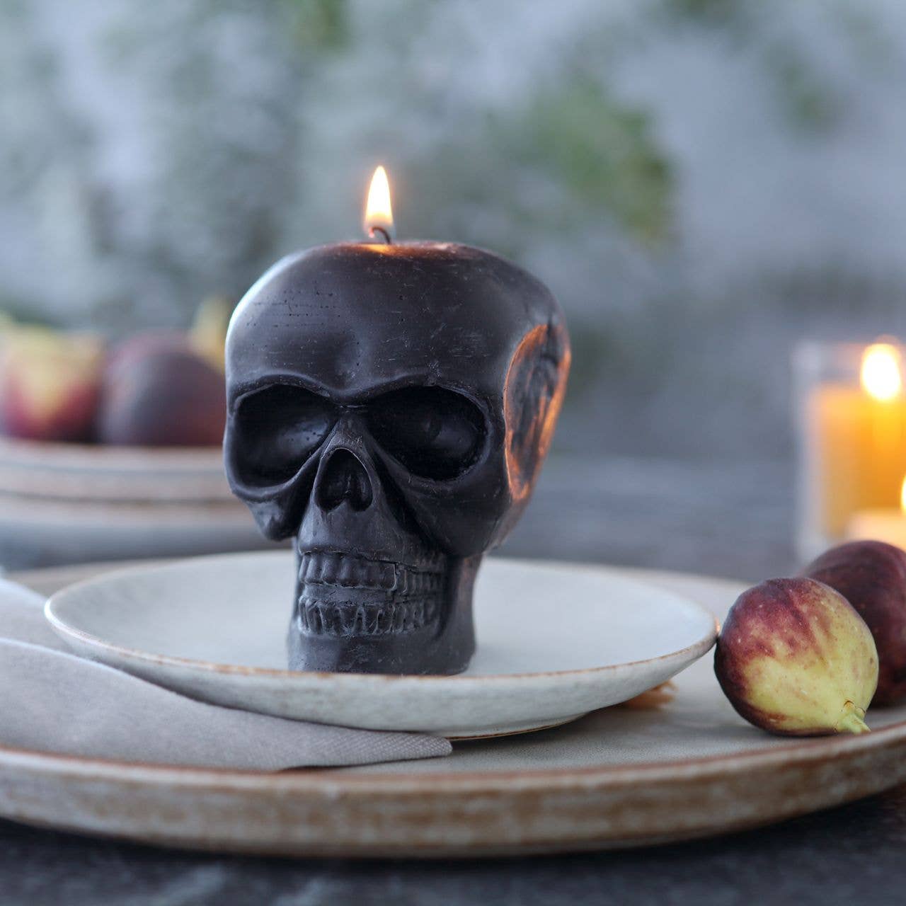 Skull-shaped candle on a plate 