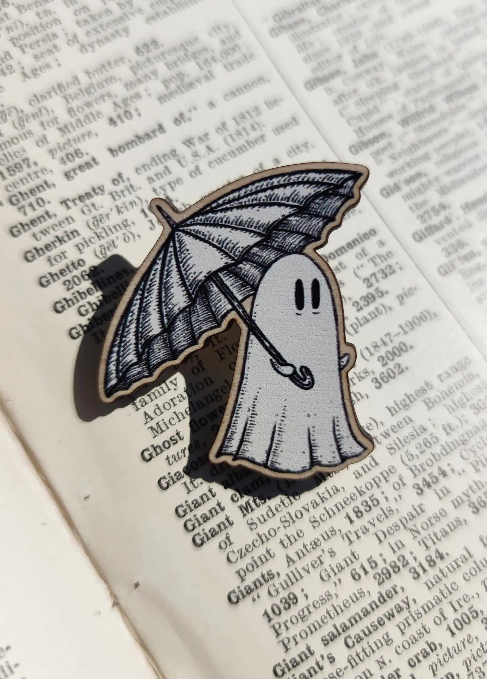 wood ghost pin carrying an umbrella