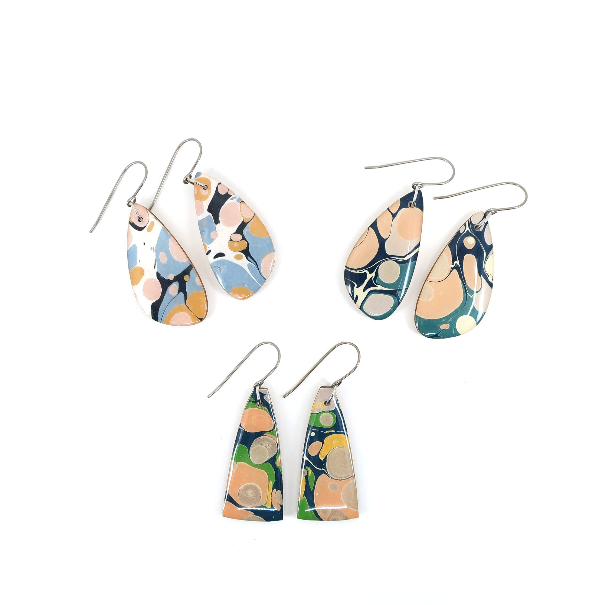 Wearing Navy, Green, Coral Pink Marble Dangle Modern Earrings, highlighting their lightweight design and vibrant colors ideal for stylish outfits.