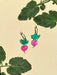 Colorful Mini Radish Dangle earrings by Sunnie Creative, featuring vibrant pink radish design with green leaves, set against a soft beige background.