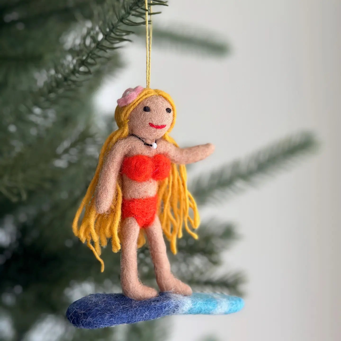 Felt Surfer Girl Ornament with blond hair, adorned in a bikini and pearl choker, adding a fun beachy touch to holiday decor.