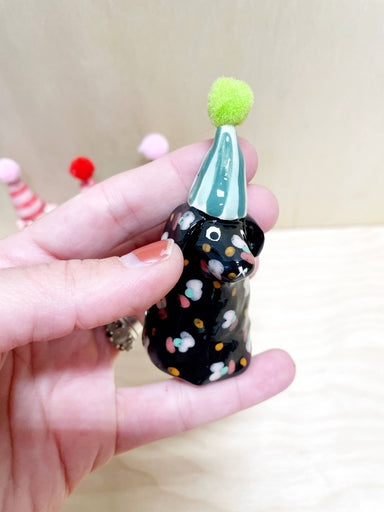 Mini party dog in a black coat with colorful polka dots and a mint green party hat, handcrafted by Bianca Rae. Perfect for festive décor as part of 'Party Minis! Mini Party Dogs in Party Hats.'