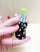 Mini party dog in a black coat with colorful polka dots and a mint green party hat, handcrafted by Bianca Rae. Perfect for festive décor as part of 'Party Minis! Mini Party Dogs in Party Hats.'