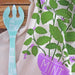 I Lilac Purple Tea Towel set presented in a compostable container, combining style and sustainability.