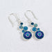 Elegant blue geometric crystal round earrings by Mosaico Jewels showcasing a unique design with shimmering stones.