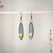 Turquoise with Solid Gold Striped Earrings showcased by The Artifact House, featuring a handmade design with a distinct 24K gold stripe.