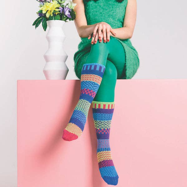 Pair of Bluebell Crew Socks displayed on a wooden background, highlighting the softness and comfort of recycled cotton fabric.
