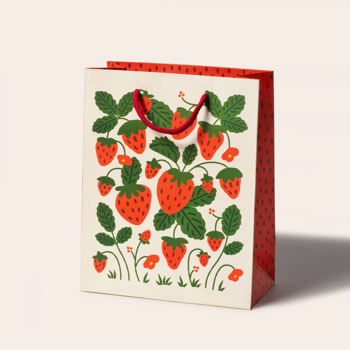 Strawberries Gift Bag by Seltzer Goods, featuring a colorful design of strawberries and leafy vines on a sturdy paper bag, perfect for gifts.