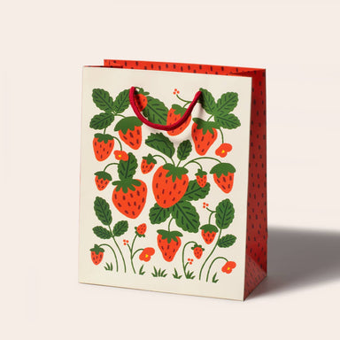 Strawberries Gift Bag by Seltzer Goods, featuring a colorful design of strawberries and leafy vines on a sturdy paper bag, perfect for gifts.