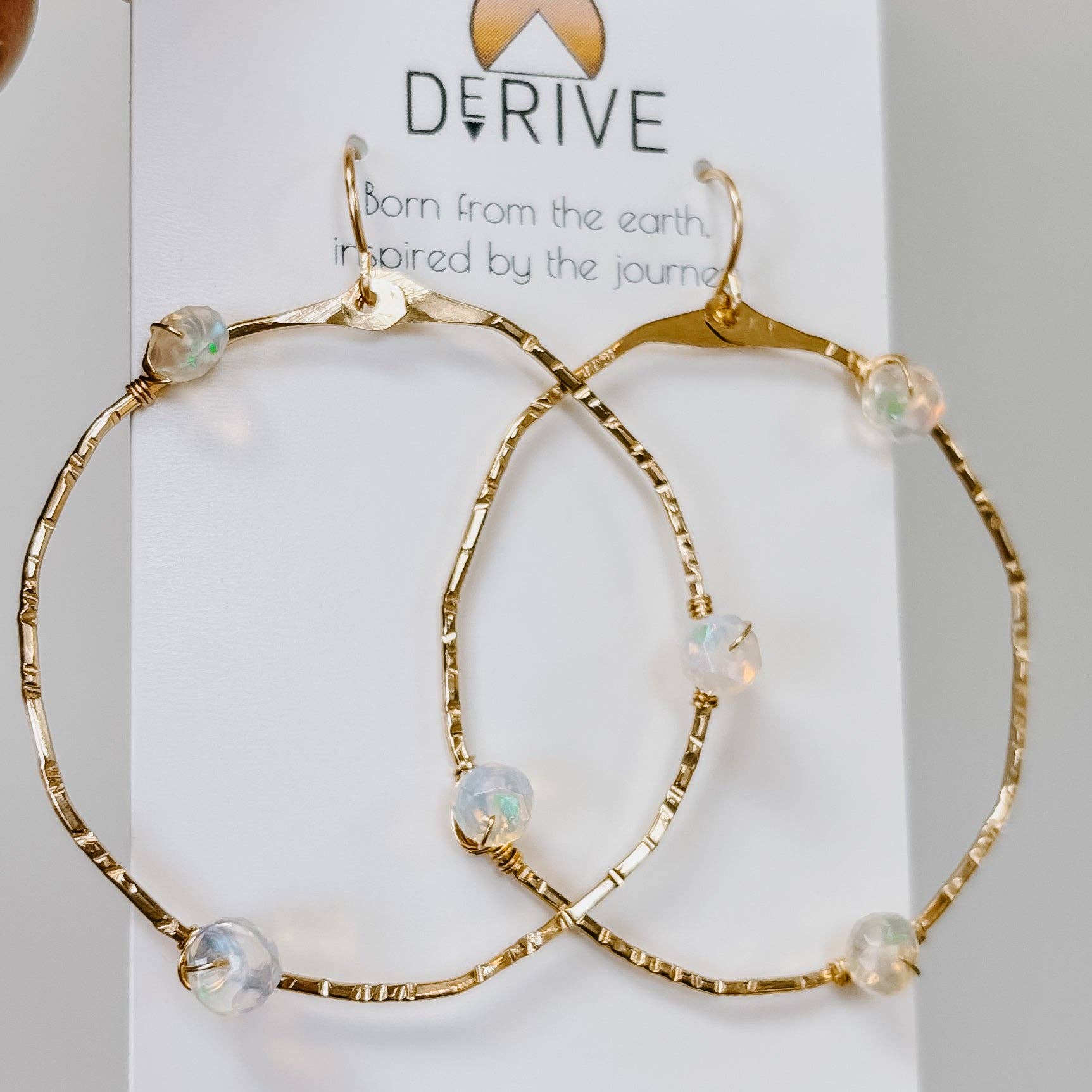Sparkle and shine with Stargazer Opal Hoop Earrings, because regular earrings just can't handle this level of fabulous! Perfect for adding a pop of glamour.