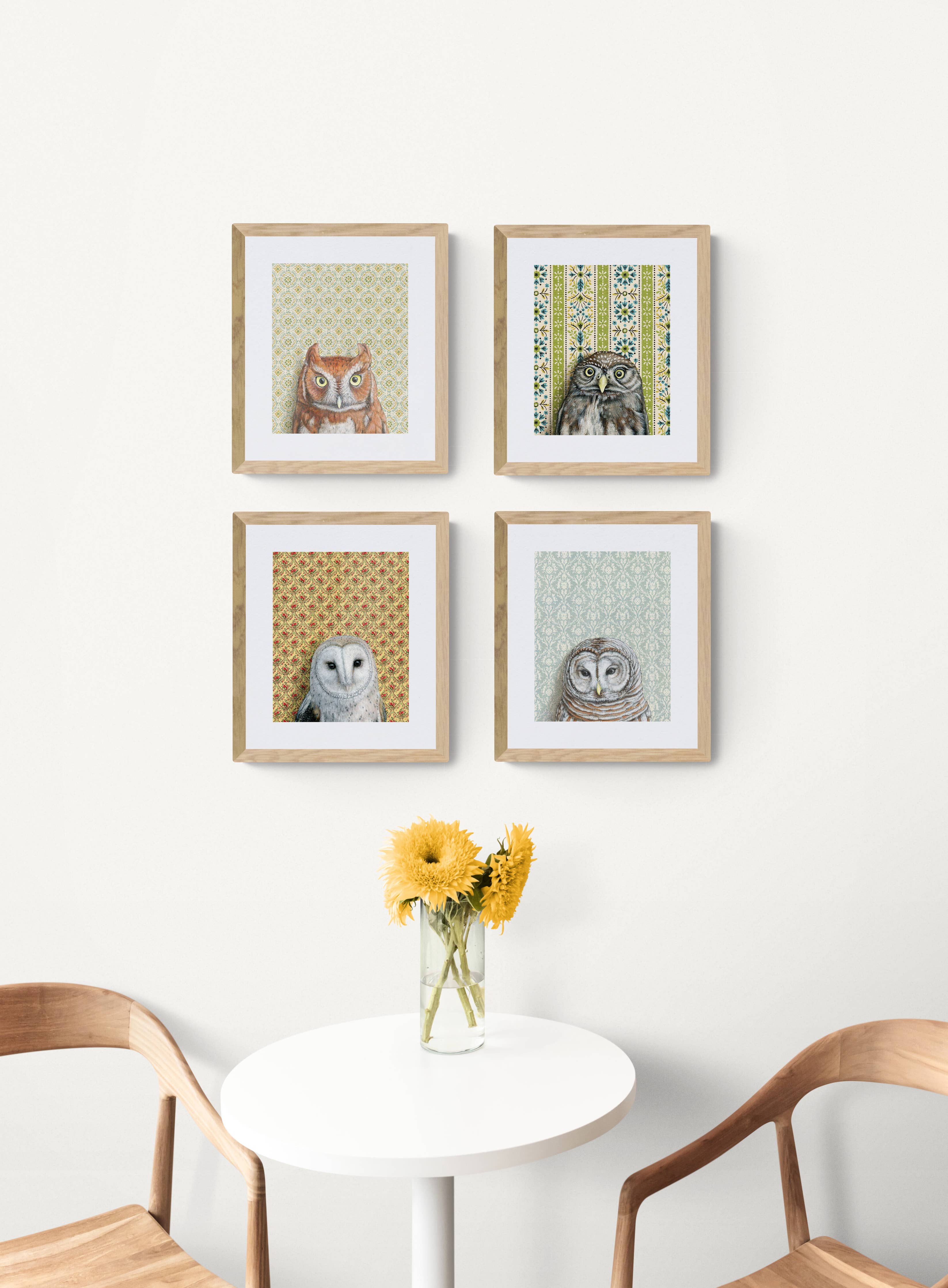 4 framed owl prints above a table
