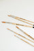 Artist using the Round Tip Watercolor Brush Set - 6 piece for delicate line work in their creative project.