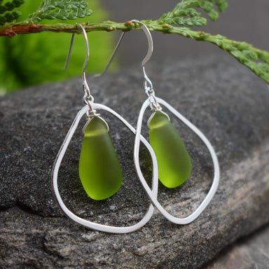 Close-up view of Green Eco Glass Teardrop Frame Earrings highlighting recycled glass drops and elegant design.