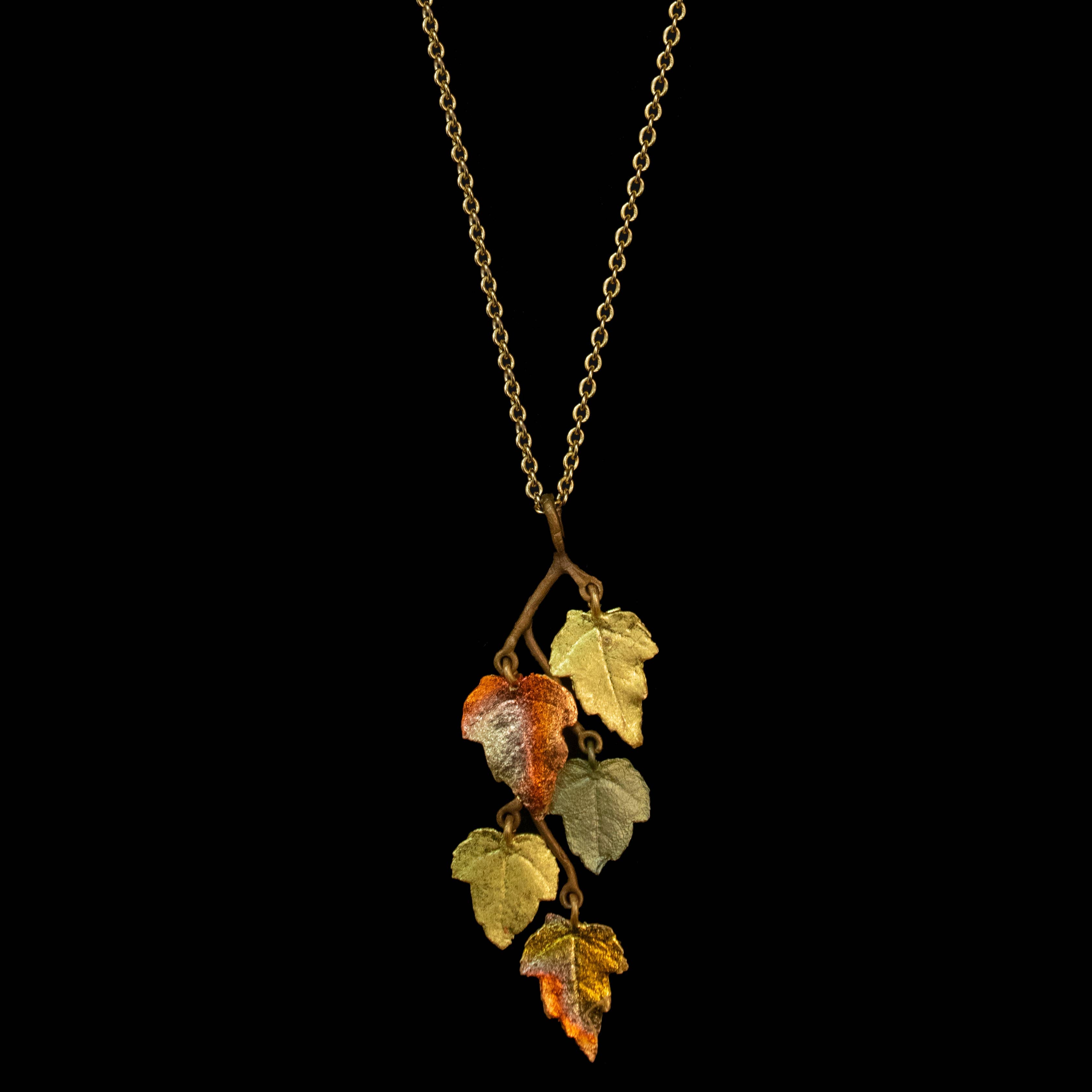Elegant Sugar Maple 16" Adjustable Pendant by Michael Michaud featuring cast bronze with a brown and green hand patina finish, accented with 24K gold and copper leaf.