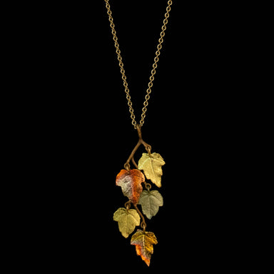 Elegant Sugar Maple 16" Adjustable Pendant by Michael Michaud featuring cast bronze with a brown and green hand patina finish, accented with 24K gold and copper leaf.