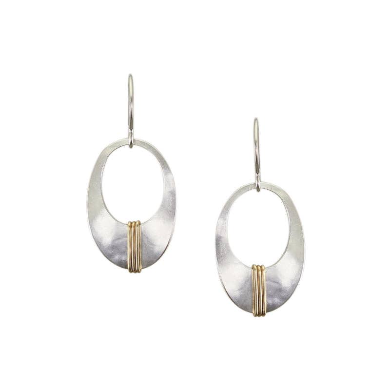 Small Wrapped Oval Frame Wire Earrings by Marjorie Baer featuring a silver cutout oval shape with brass wire wrapping, showcasing a unique and sculptural design.