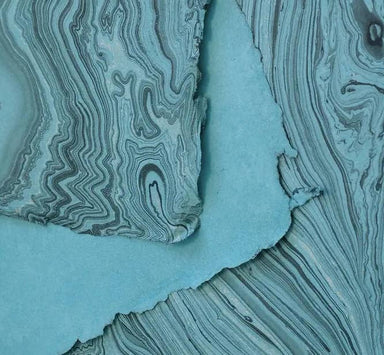 Close-up of a hand marbled softcover notebook page, highlighting the intricate marbling design, by The Casual Bookbinder.