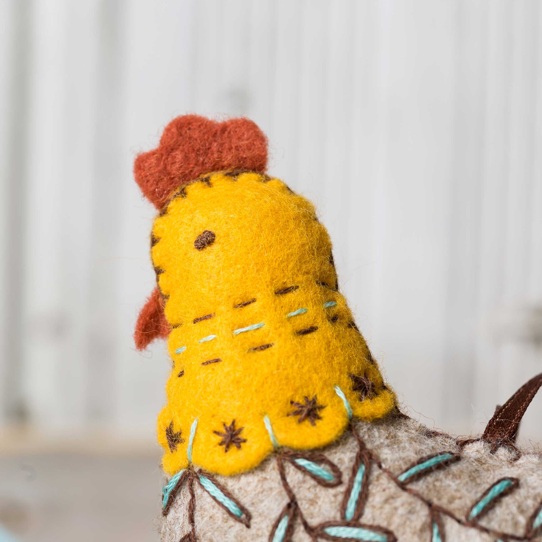 Inside the French Hen Felt Craft Mini Kit, featuring plump felt pieces, DMC embroidery threads, and all you need for a fowl crafting adventure.
