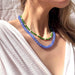 Model wearing the Cornflower Stone Candy Beaded Necklace by The Silver Wren, showcasing the cheerful jade stones in vibrant blue and green colors.