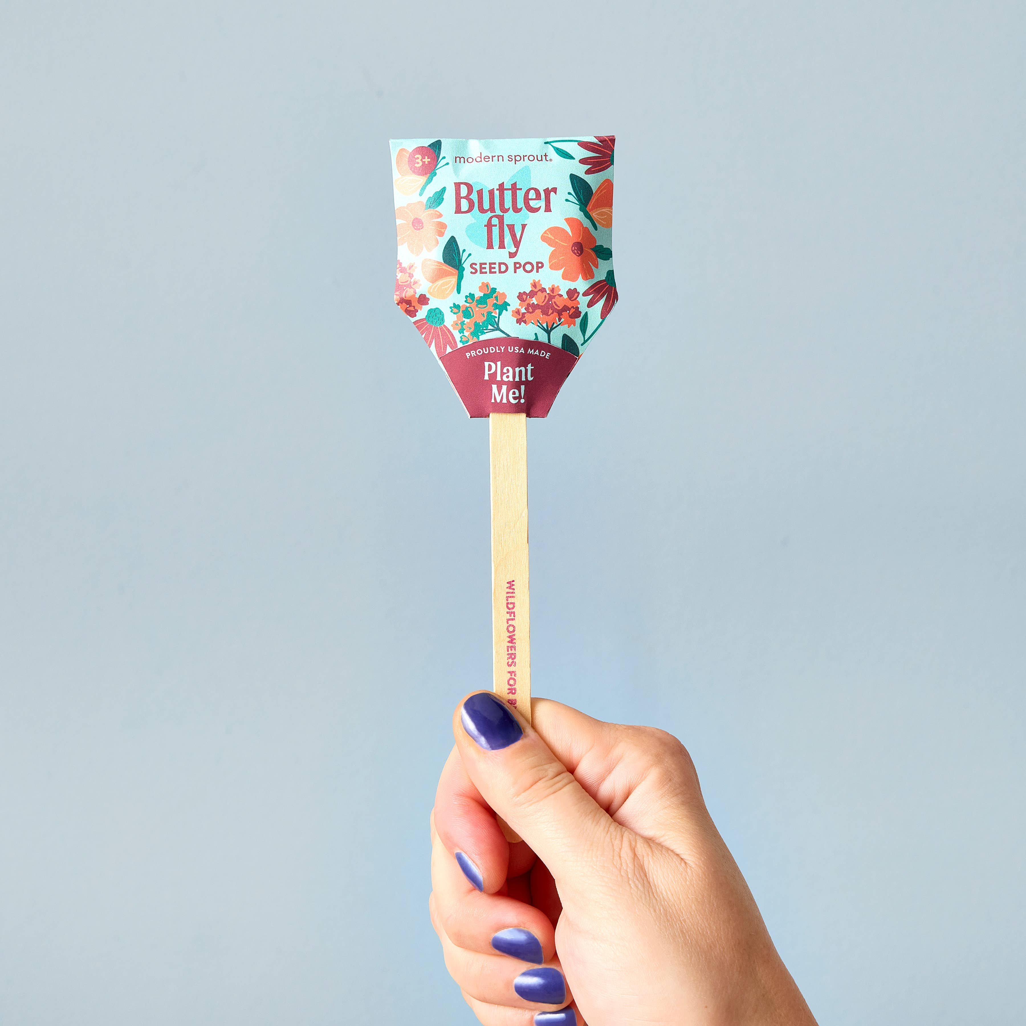 A close-up of the Butterfly seed pop by Modern Sprout, showcasing its colorful packaging and wooden stick that encourages planting.