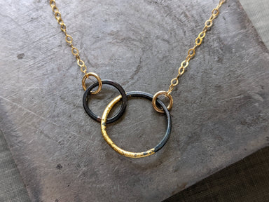 Petite Steel & Gold Interlocked Circles Necklace featuring brazed blackened steel circles accented with 23k gold—small in size, big on style.