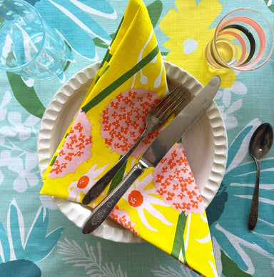 Close-up of Allium Napkin Set, showcasing vibrant colors and cheerful patterns on 20x20 inch napkins.