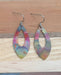 Pointed Teardrop Fire Painted Copper Earrings hanging from stainless steel ear wires showcasing vibrant colors.