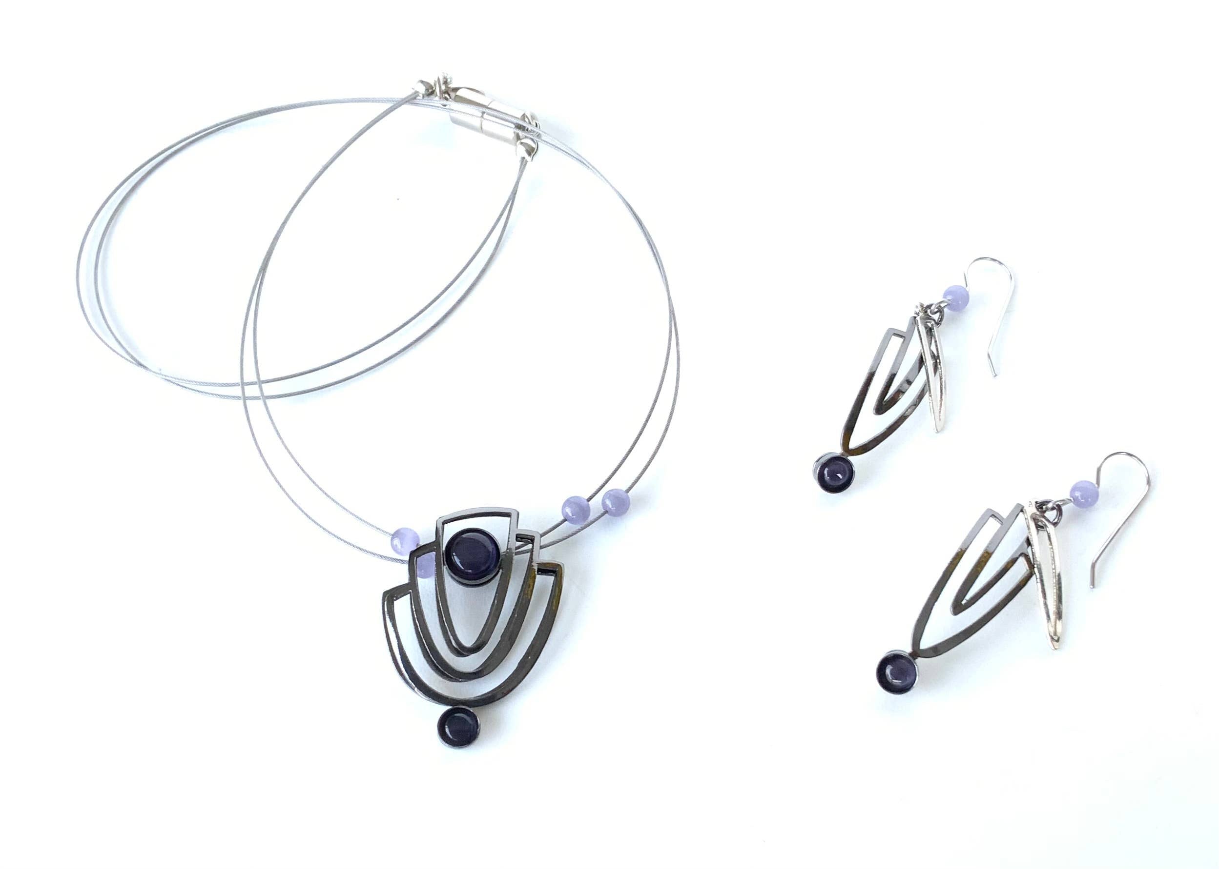 wire necklaces and earrings featuring black beads and gemstones