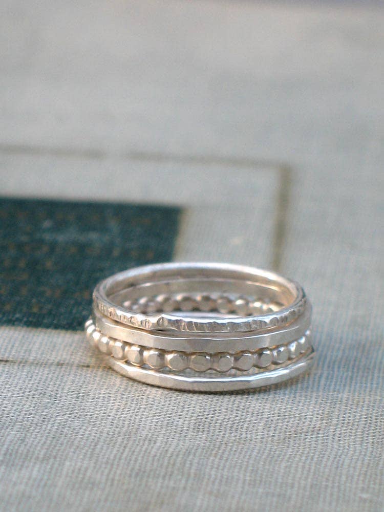 Dazzling Silver Stacking Rings - set of 4, because who says you can't play with your jewelry? A hammered texture adds character to your collection!