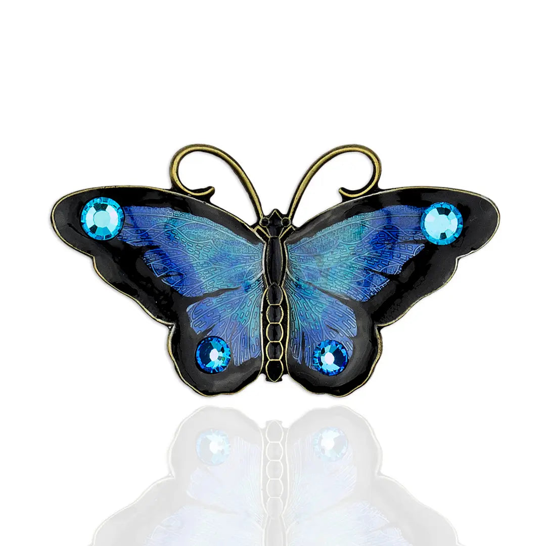 Elegant Crystal Butterfly Brooches designed by Anne Koplik, featuring intricate enamel work and embellished with shimmering crystals, symbolizing endurance and hope.