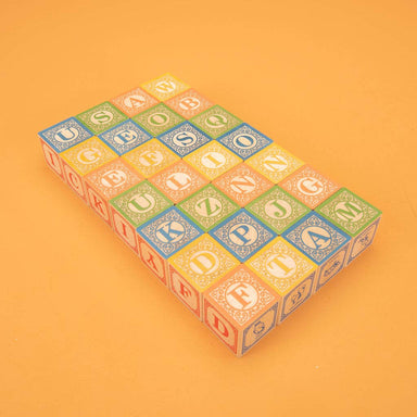 A playful arrangement of Uncle Goose Classic ABC Blocks featuring vibrant numbers and symbols, sparking joy in learning and creativity.