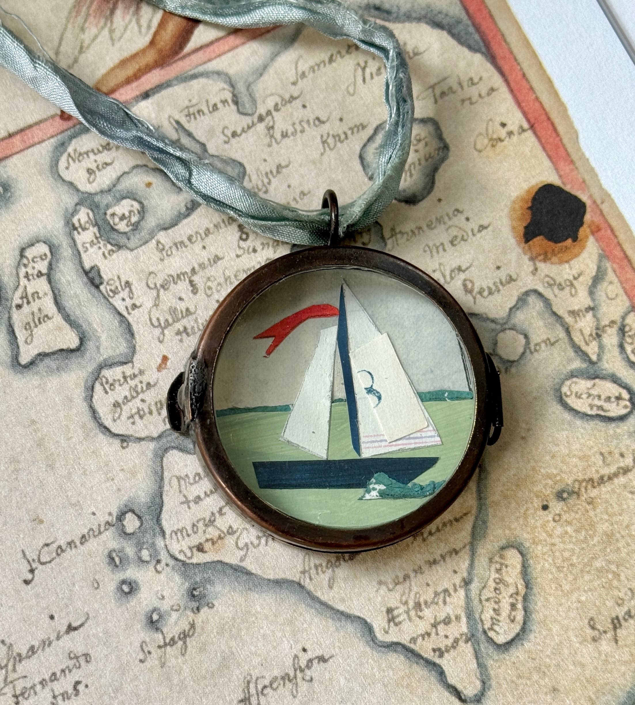 Vintage-style nautical boat art locket ornament.