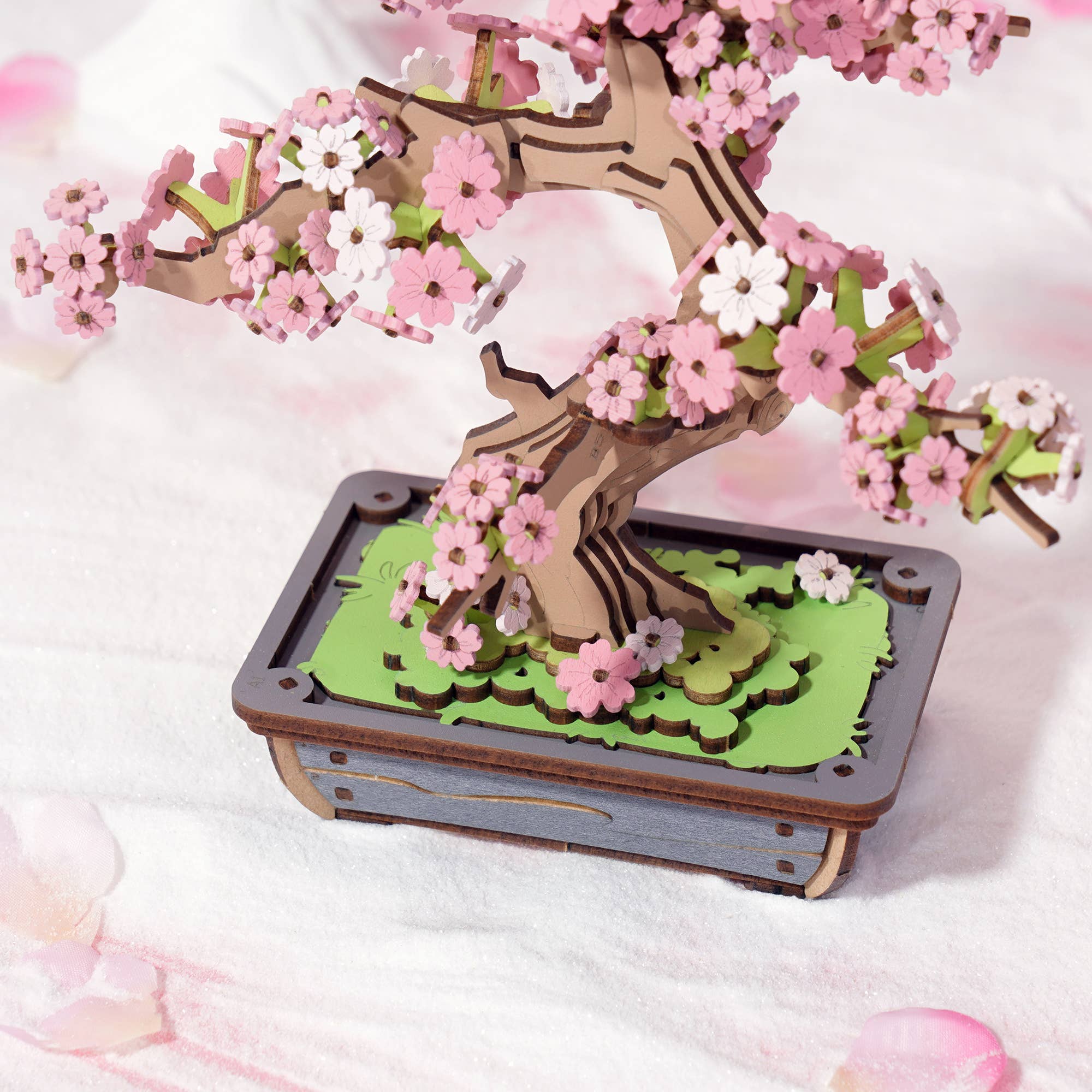 Sakura Bonsai Modern Wooden Puzzle by Hands Craft showing a beautifully crafted 3D wooden puzzle of a cherry blossom bonsai tree with delicate pink and white flowers.