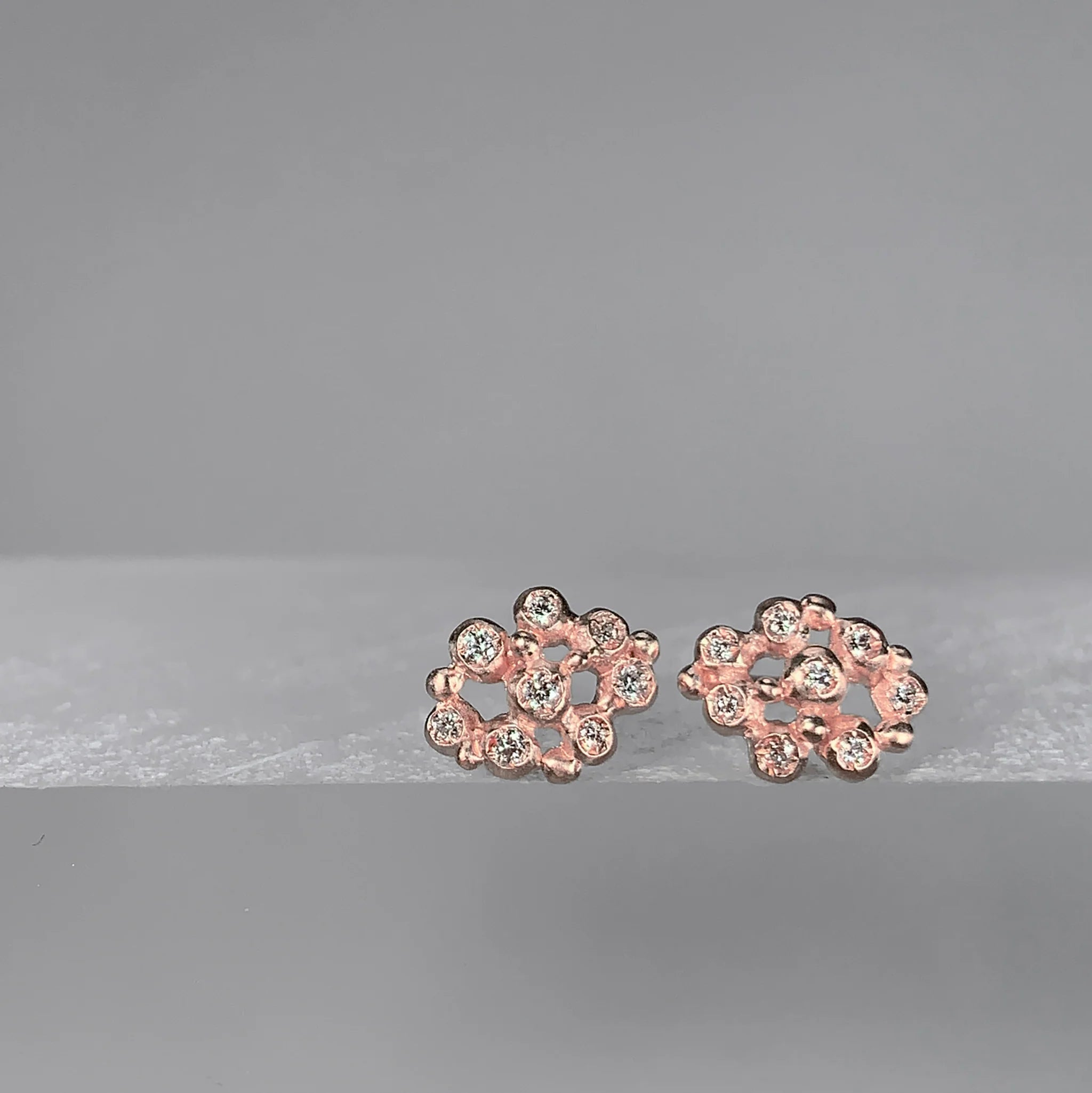 Pair of rose gold floral-shaped earrings