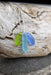 Close-up view of the Eco Glass Trio Sterling Silver Necklace showcasing the intricate wire-wrapping of recycled glass drops, highlighting its eco-friendly design.