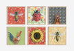 Collection of framed fine art prints, including the Honeybee Red illustration by Emily Uchytil, showcasing various nature-themed designs in a vibrant display.