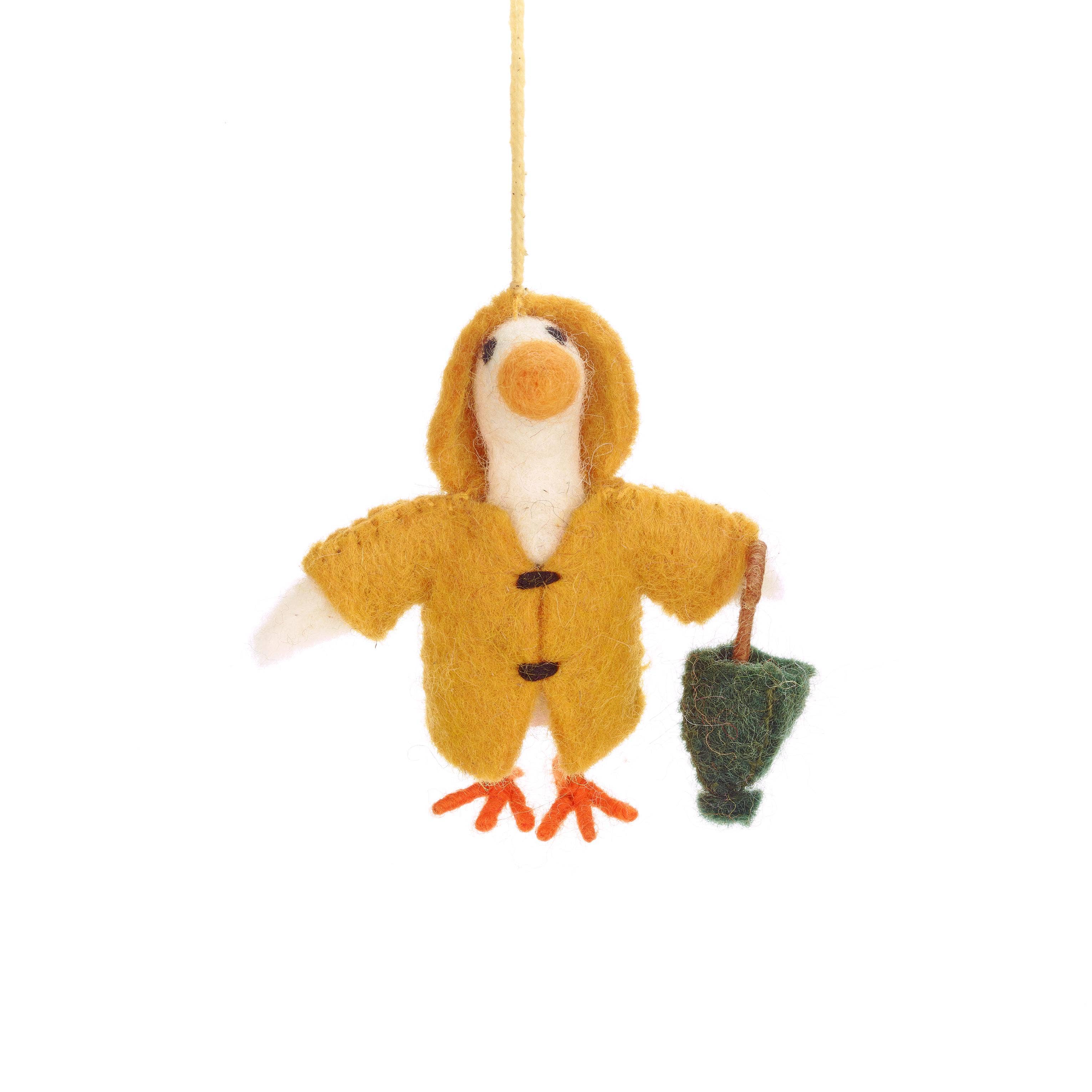 Felted goose ornament in yellow raincoat holding a green umbrella