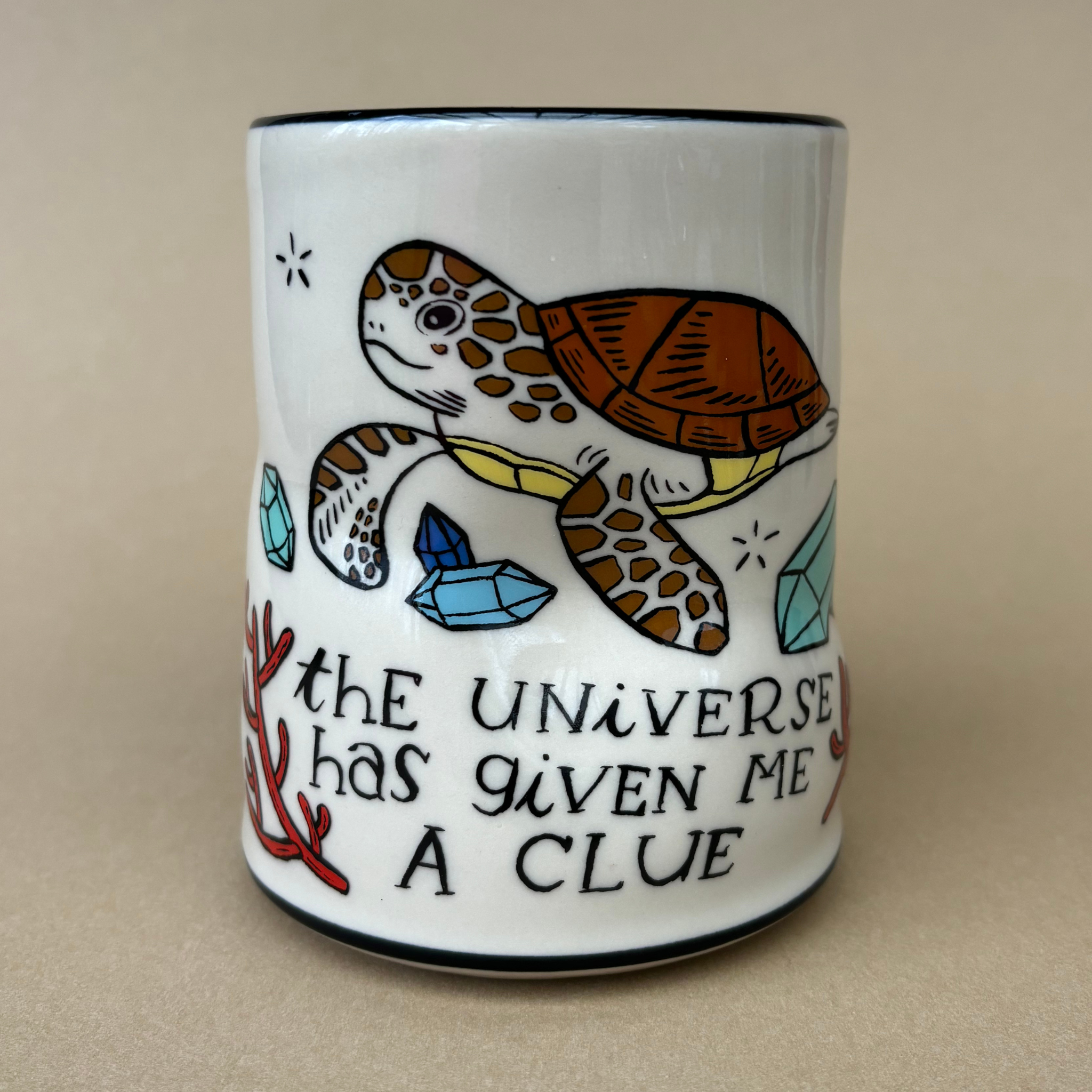 XLarge Lucky Sea Turtle Cup by The Bowl Maker showcasing a vibrant illustration of a sea turtle surrounded by turquoise crystals and the quote 'the universe has given me a clue'.