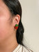 Side view of Mini Strawberry Acrylic Dangle Earrings by Sunnie Creative worn by an individual, showcasing the unique strawberry design.