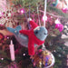 Felted narwhal ornament with a red scarf on a chrismas tree