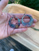 Close-up of Boho Large circle earrings showcasing their one-of-a-kind torch-painted copper patterns.
