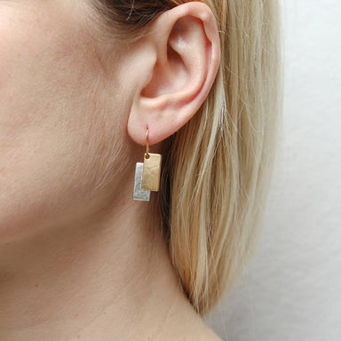 Layered Rectangles Wire Earrings by Marjorie Baer worn by a woman, highlighting the earrings' design and contemporary style against a neutral background.