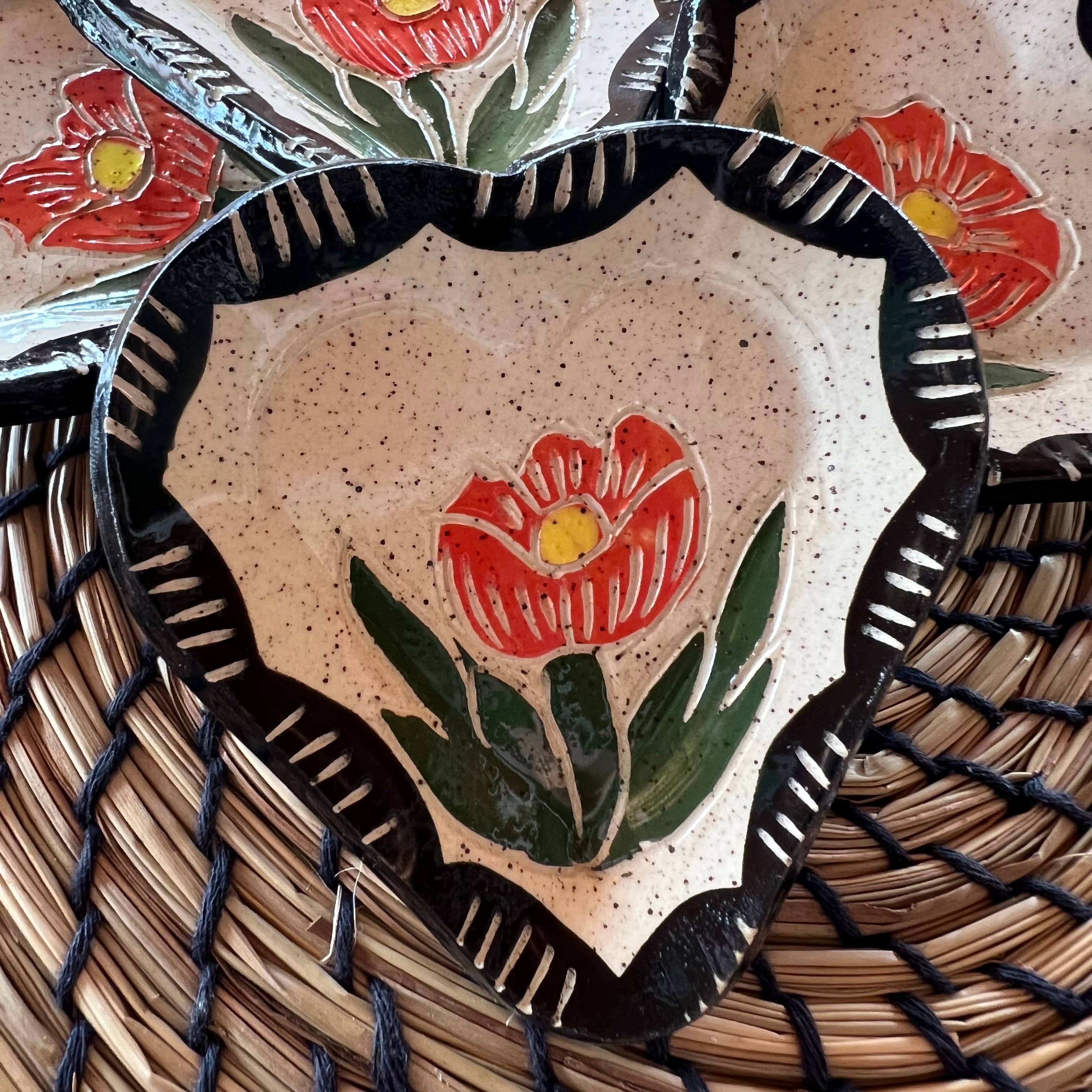 One Floral Sgraffito Heart Trinket Dish highlighting a central orange flower design, elegantly presented by Tough Kitty Designs.