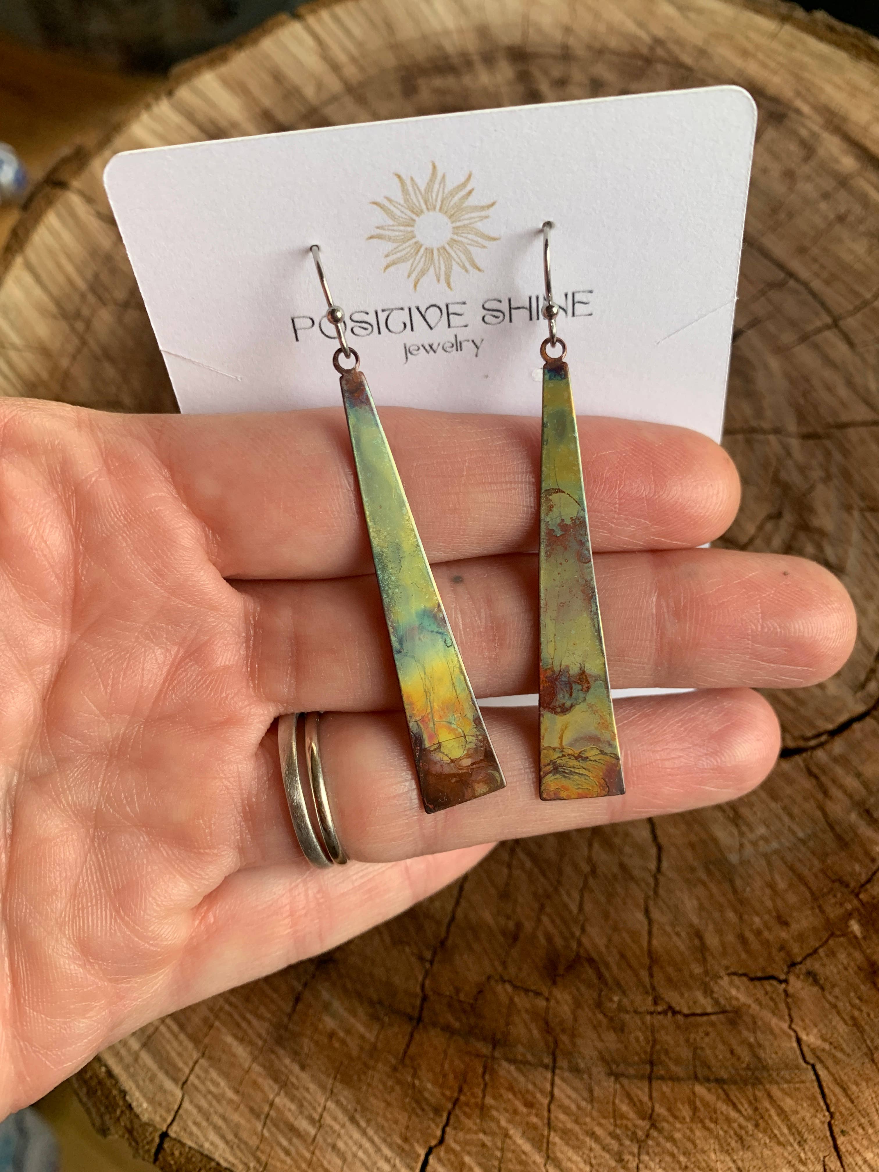 Creative presentation of Triangle Stick Earrings by Positive Shine Jewelry, perfect for complementing any outfit.