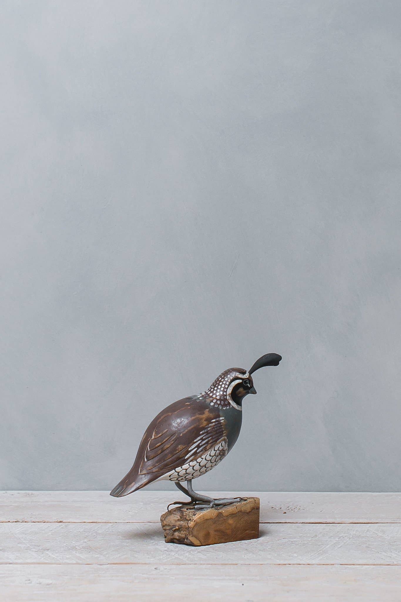 painted quail on wood stump